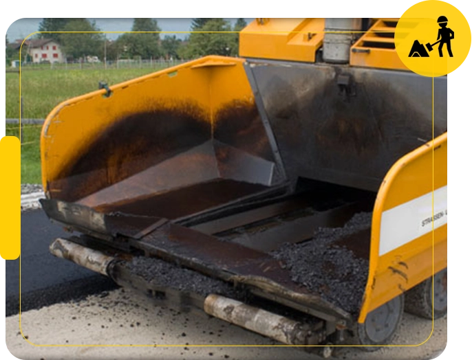 A yellow and black machine is on the road