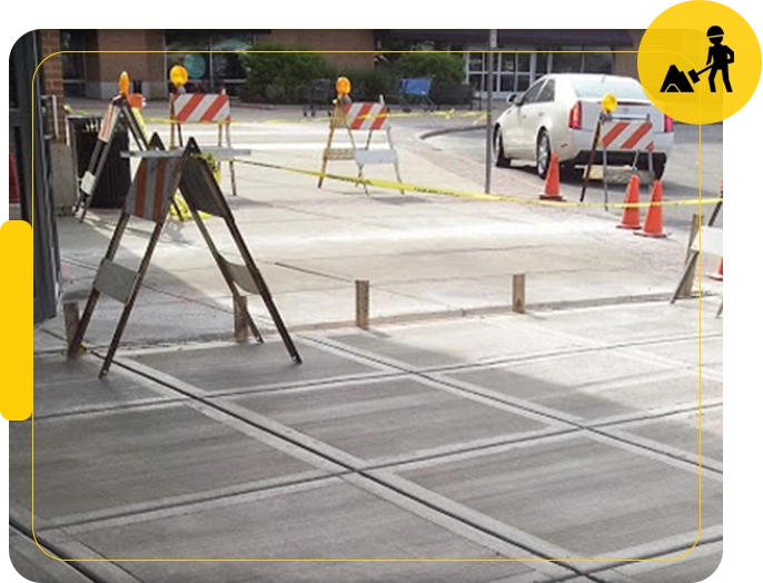 A construction site with cones and ladders on the ground.