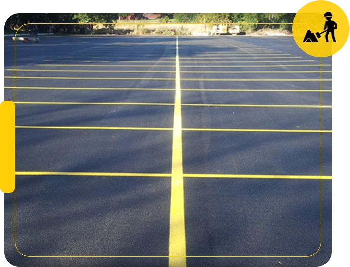 A parking lot with yellow lines on the side.