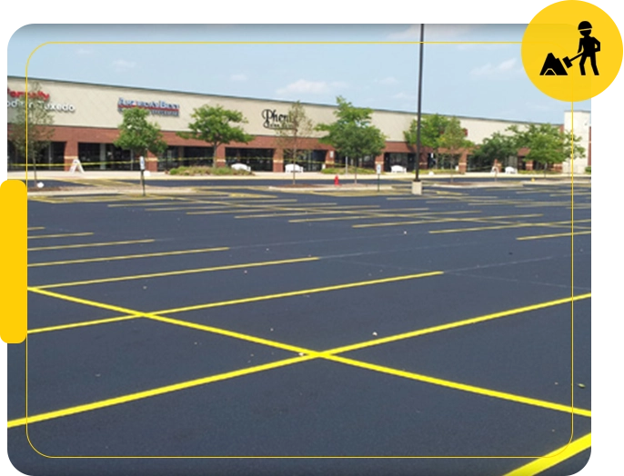 A parking lot with yellow lines on the ground.