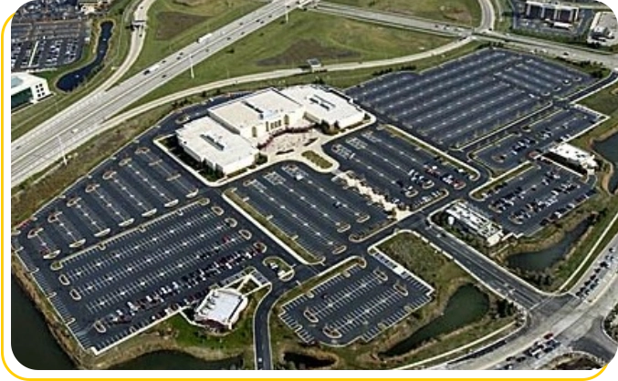 A large parking lot with many cars parked in it.